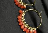 Orange hoop earrings by Zarwish Javid