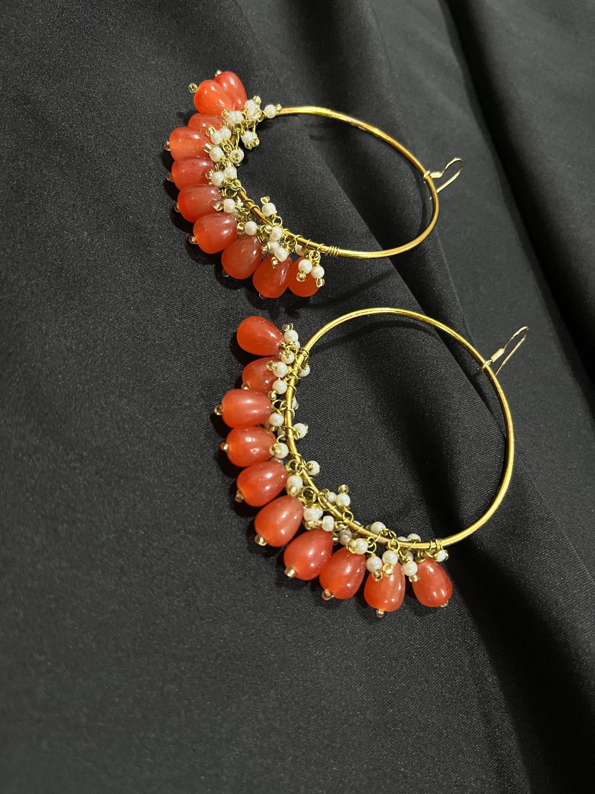 Orange hoop earrings by Zarwish Javid