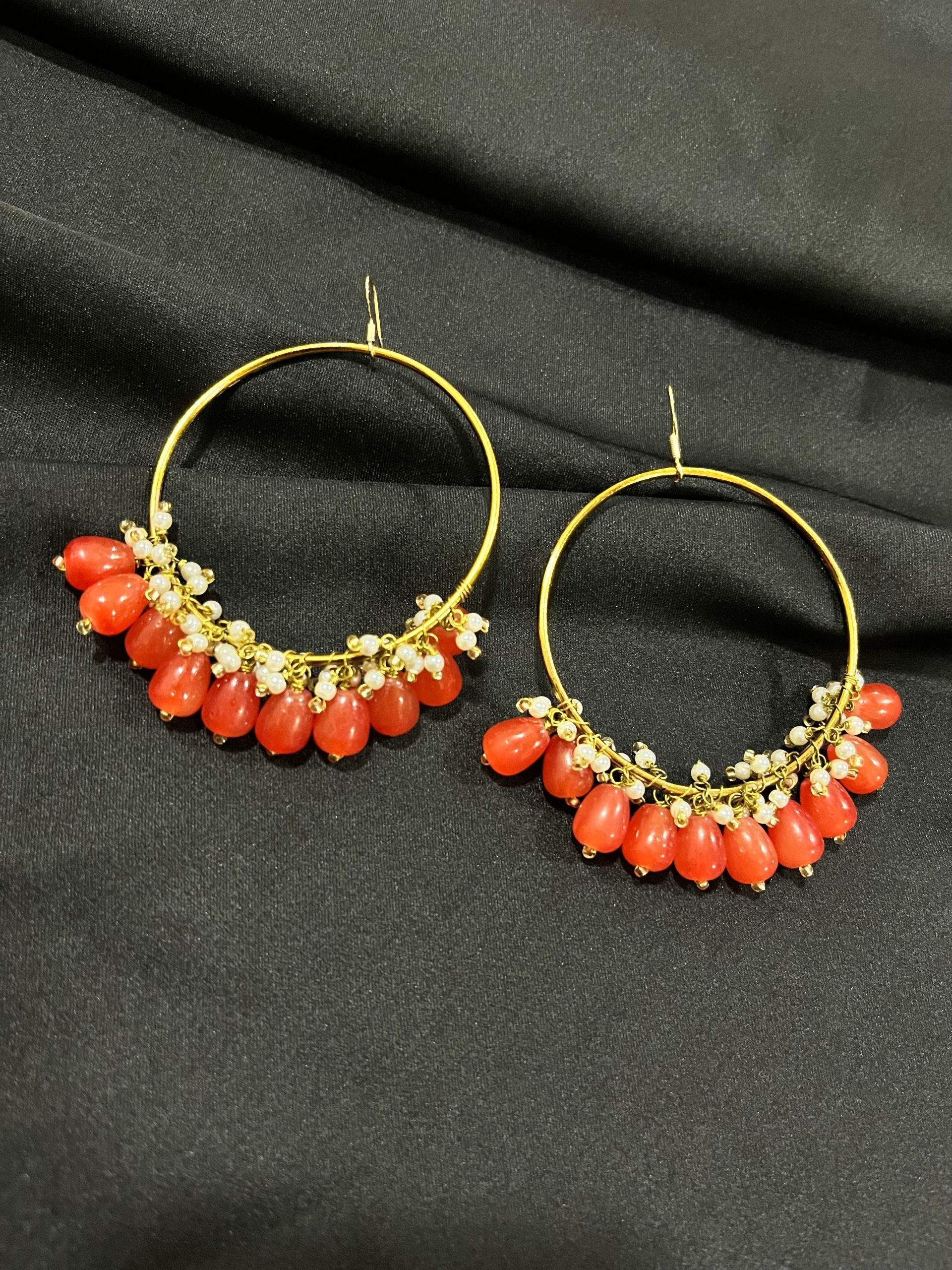 Orange hoop earrings by Zarwish Javid