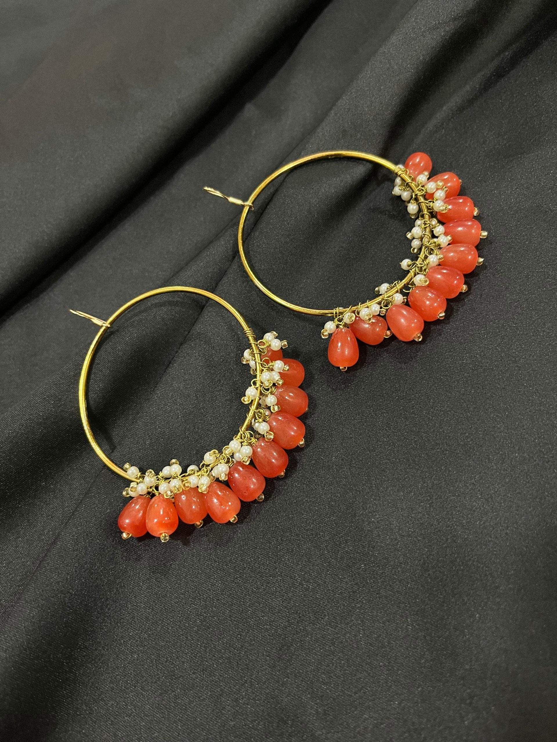 Orange hoop earrings by Zarwish Javid