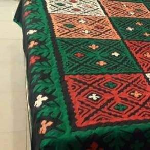 Balochi dress and handmade bed sheets by Siraj Baloch