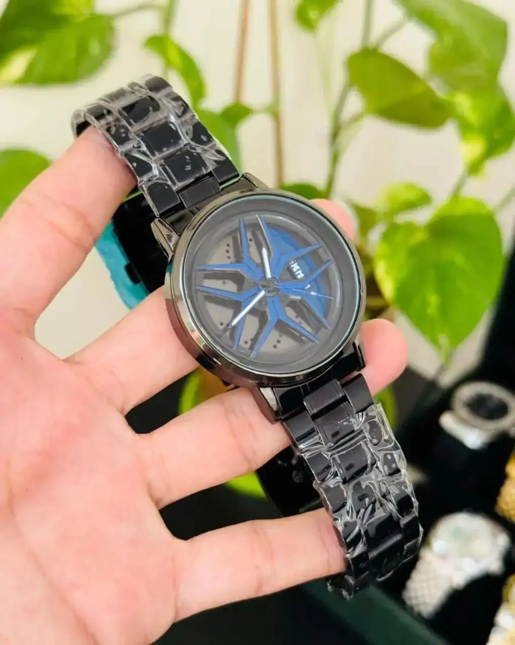 Spinning watch blue dial black strap multicolour