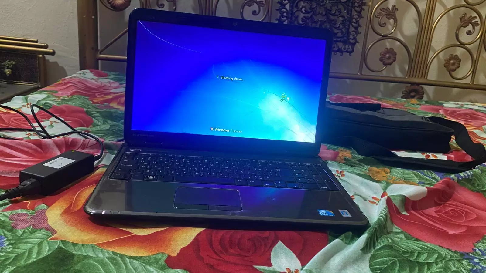 Dell Inspiron N5010 laptop with a silver chassis and a large keyboard.