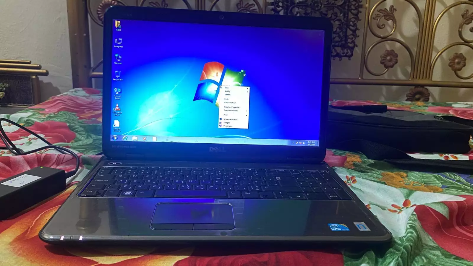 Dell Inspiron N5010 laptop with a silver chassis and a large keyboard.