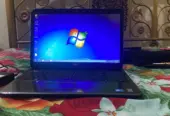 Dell Inspiron N5010 laptop with a silver chassis and a large keyboard.