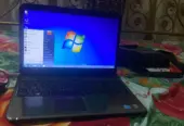 Dell Inspiron N5010 laptop with a silver chassis and a large keyboard.
