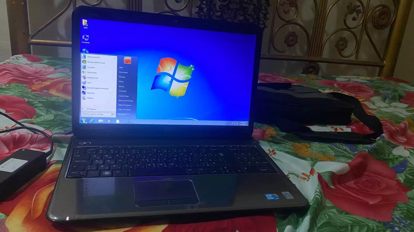 Dell Inspiron N5010 laptop with a silver chassis and a large keyboard.