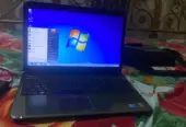 Dell Inspiron N5010 laptop with a silver chassis and a large keyboard.