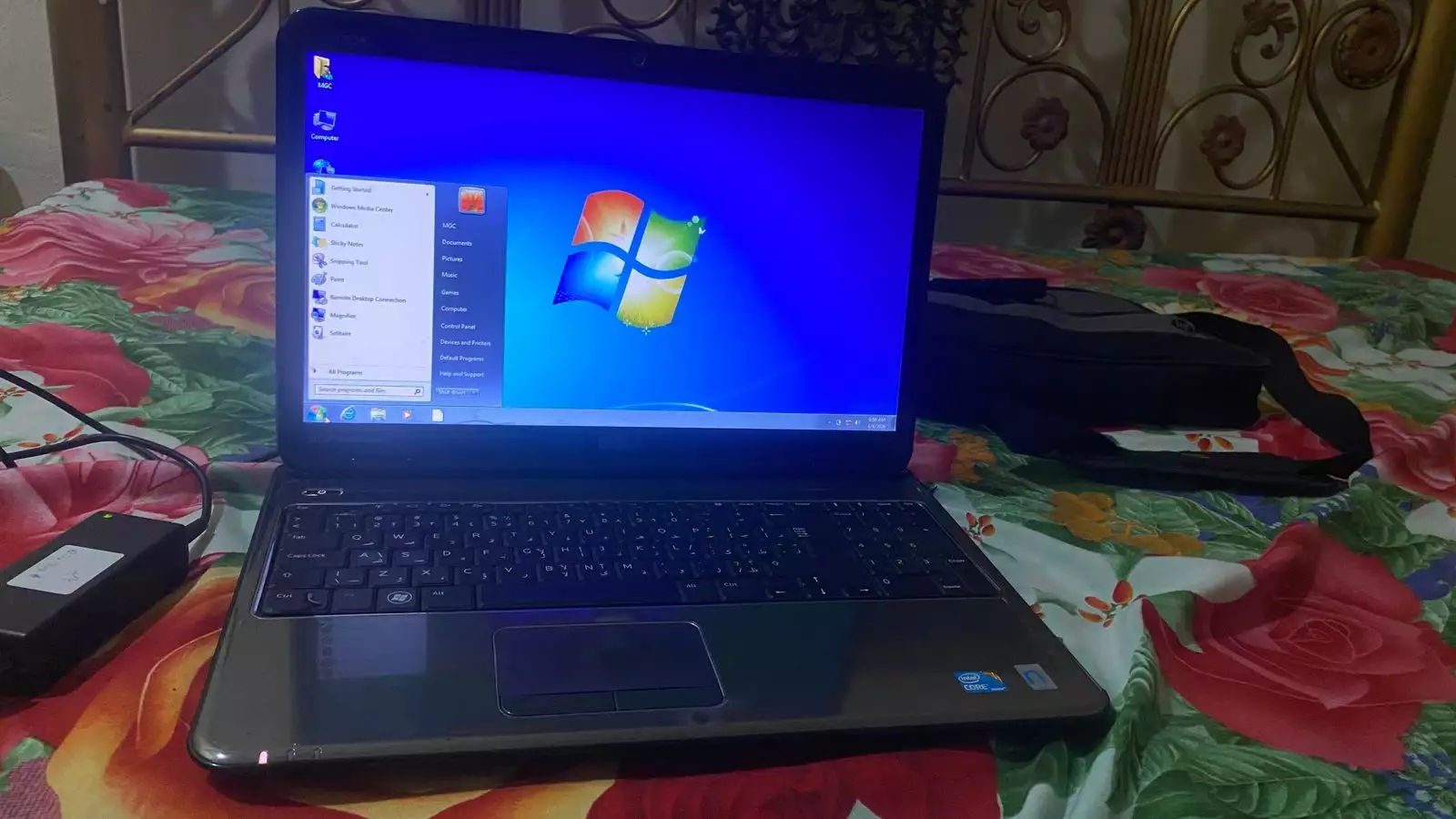 Dell Inspiron N5010 laptop with a silver chassis and a large keyboard.